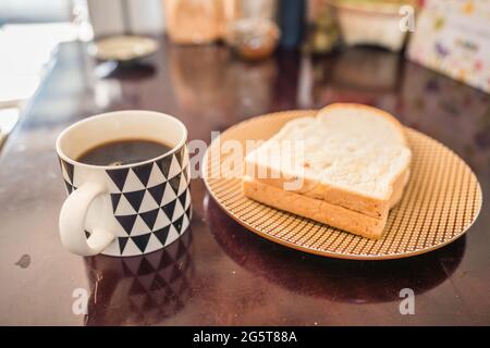 Cup of coffee and bread on the table Stock Photo