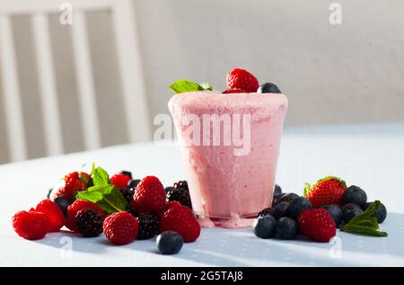Glass of milk and berry smoothie with ingredients Stock Photo