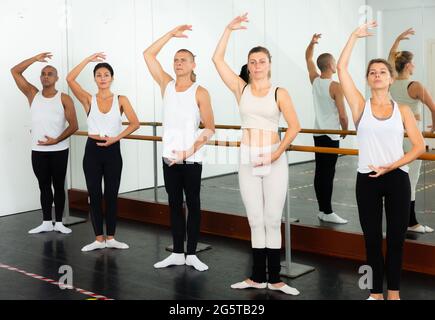 Group of multiethnic dancers training in bright fitness room Stock Photo
