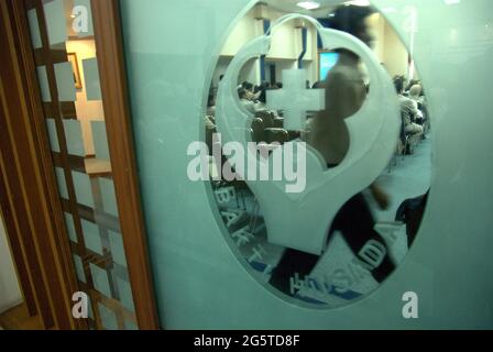 Jakarta, Indonesia. 7th April 2008. A media and public seminar is held in Leimena Room (pictured) at the Indonesian Ministry of Health office, as seen through a glass decorated with the logo of the ministry. The seminar is a part of a series of event to celebrate the 2008 World Health Day in Jakarta. The theme for the 2008 celebration is 'protecting health from climate change'. Stock Photo