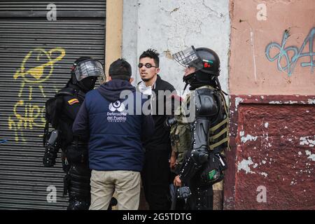 Medellin, Antioquia - Colombia on June 28, 2021. A member of the ombudsman office talks to free two arrested demonstrators as anti-government protests rise into clashes between demonstrators and Colombia's riot police (ESMAD), amidst political tensions against the government of president Ivan Duque, police brutality cases and inequalities as Colombia marks a second month of Anti-Government Protests, in, Pasto, Narino - Colombia on June 28, 2021. Stock Photo