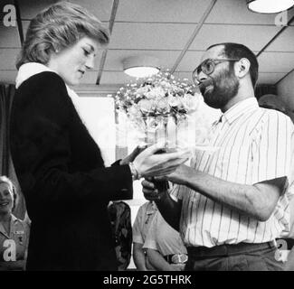 File photo dated 24/02/89 of Diana, Princess of Wales being presented with a bouquet by AIDS patient Martin Johnson during her visit to the Mildmay Mission Hospital AIDS Hospice in East London. The Duke of Cambridge and the Duke of Sussex are preparing to honour their mother Diana, Princess of Wales by unveiling a statue on Thursday on what would have been her 60th birthday. Issue date: Wednesday June 30, 2021. Stock Photo