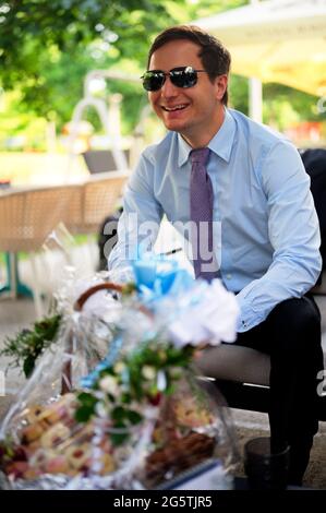 A handsome man formally dressed sitting in a cafe Stock Photo