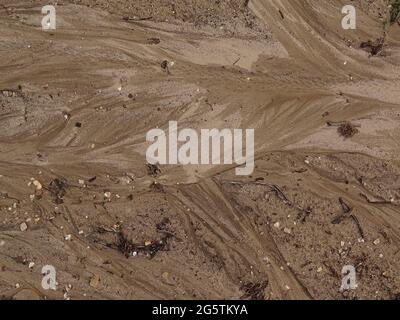 sand pattern after a rain shower, with beautiful structures in brown, yellow and gray Stock Photo