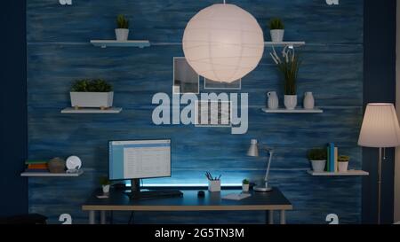 Front view of modern empty room with nobody in it ready for birthday party late at night. Living room having potato chips bowl on woden table, apartament is ready for friends gathering Stock Photo