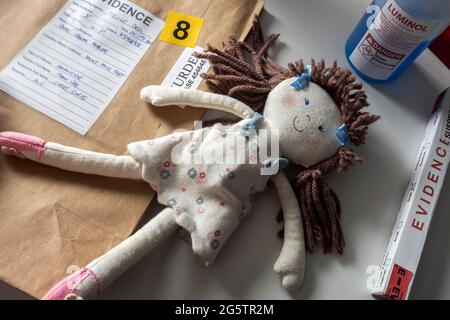 Testing of a rag doll implicated in a murder at a crime lab for DNA analysis, conceptual image Stock Photo