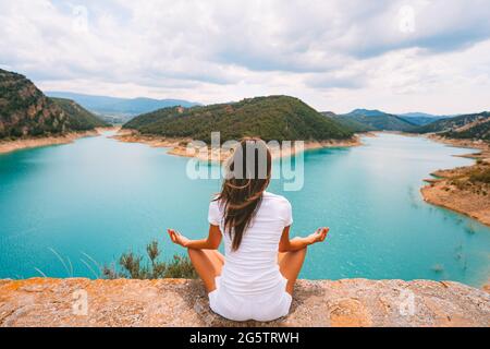 Healthy young woman meditating or practicing yoga in nature. Relaxation, harmony Stock Photo