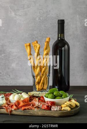 Appetizers board with different italian antipasti, cheese, charcuterie, snacks and wine.  Stock Photo