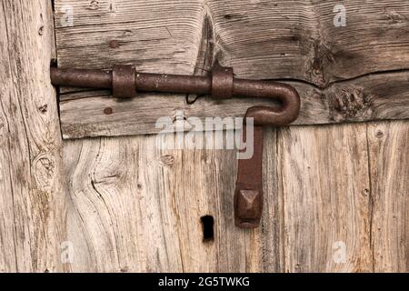 Old sliding bolt lock on antique wooden door Stock Photo