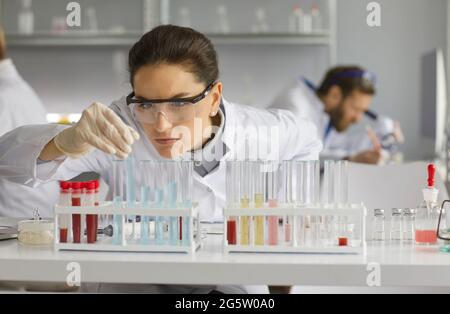 Portrait of a focused female chemist working in a modern medical science laboratory Stock Photo