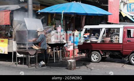 Klong Toey Market Wholesale Wet Market Bangkok Thailand largest food distribution center in Southeast Asia Man cooking meats Stock Photo