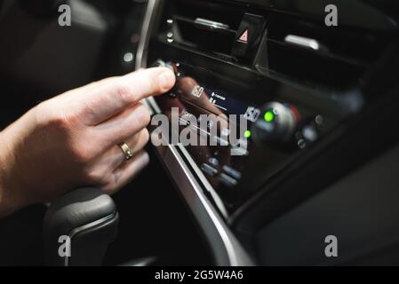 Male driver controls the settings of his car with buttons Stock Photo ...