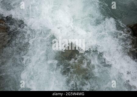 Wild flowing water in a mountain stream Stock Photo