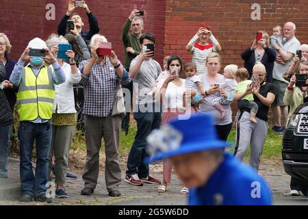 Members of the public photograph Queen Elizabeth II during her visit to a community project in Glasgow, as part of her traditional trip to Scotland for Holyrood Week. Picture date: Wednesday June 30, 2021. Stock Photo