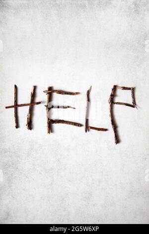 'HELP' spelt out with Twigs Stock Photo