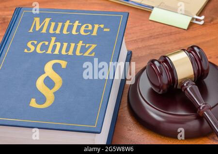 Law book with a gavel - Maternity protection in german - Mutterschutz Stock Photo