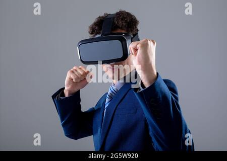 Caucasian businessman wearing vr headset, isolated on grey background Stock Photo