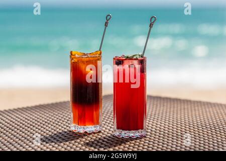 Exotic Colorful Cocktails on Table at Sea Shore, Summer Vacations Concept Stock Photo