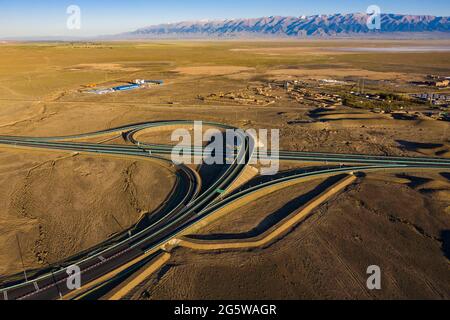 Beijing, China. 28th June, 2021. Aerial photo taken on June 28, 2021 shows a view of a flyover of the Beijing-Urumqi Expressway in Kazak Autonomous County of Barkol, northwest China's Xinjiang Uygur Autonomous Region. Credit: Hu Huhu/Xinhua/Alamy Live News Stock Photo