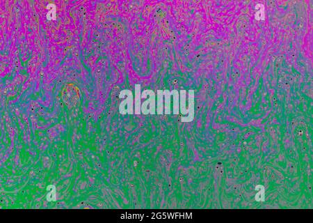 Fluid soap bubble psychedelic colorful abstract art. Surreal patterns with rainbows and waves of color in motion. Stock Photo