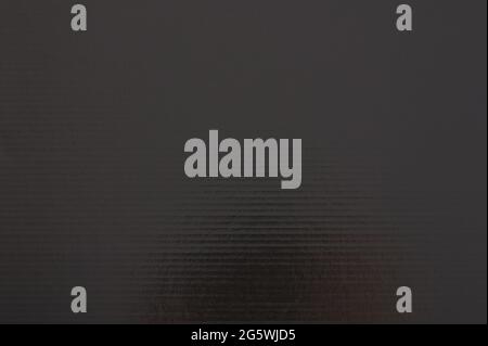 Dark grey glossy paper surface with horizontal line close up view Stock Photo