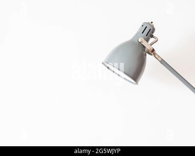 Gray home metal shade lamp with rotary mechanism on white background. Front view. copy space Stock Photo