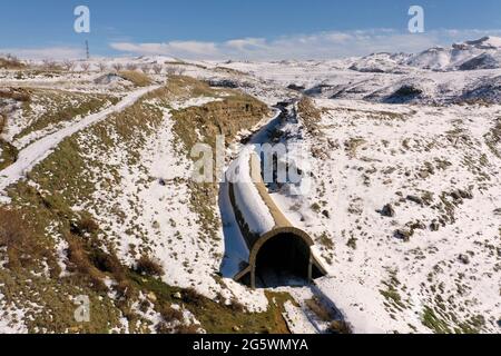 Abandoned train tunnel in snow Stock Photo