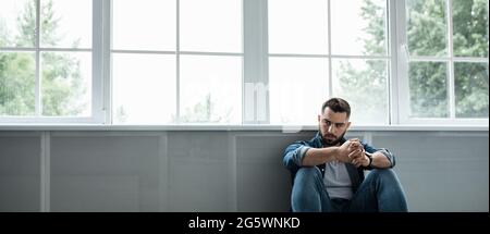 Man feeling sad, tired and worried, suffering depression in mental health, problems and broken heart Stock Photo