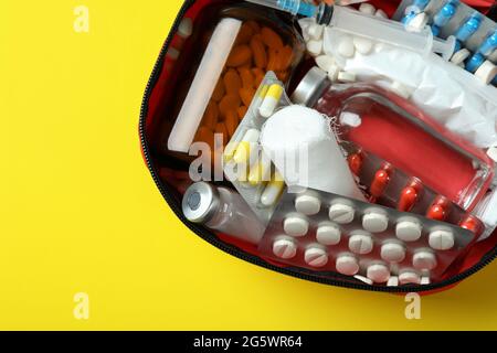 First aid medical kit on yellow background Stock Photo