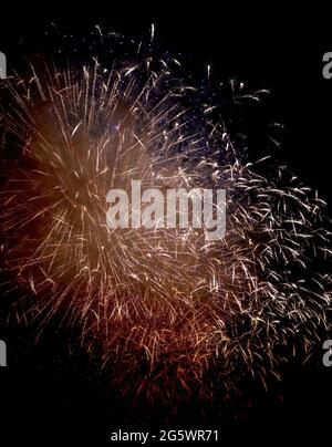 Colorful fireworks of various colors over night sky, Real Fireworks on Deep Black Background Sky on Fireworks festival show before independence day on Stock Photo