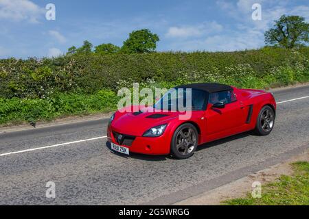 2001 red Vauxhall VX 220 cabrio en-route to Capesthorne Hall classic May car show, Cheshire, UK Stock Photo