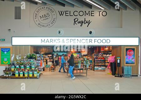 Welcome sign Marks & Spencer food shop front 2021 Moto Rugby M6 motorway services shopping mall shoppers in Covid face masks Warwickshire England UK Stock Photo