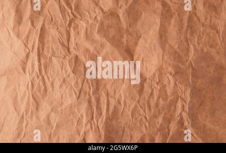 Crumpled recycled brown paper texture background Stock Photo
