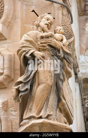 Scicli, Ragusa, Sicily, Italy. Eye-catching religious statuary on corner of the 18th century baroque Palazzo Beneventano. Stock Photo
