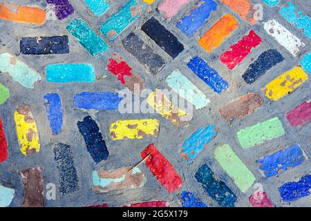 Top view on pieces of multicolored ceramic tiles decorated in garden. Old pavement of tiles textured. Street mosaic cobblestone sidewalk. Abstract,bac Stock Photo