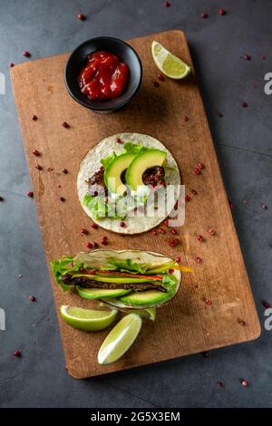 fresh taco with avocado on cutting board Stock Photo