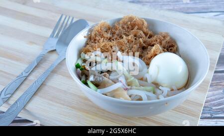 "Laksa" is a spicy noodle soup popular in the Peranakan cuisine. Selective focus of a bowl of "laksa" known in malay. Stock Photo