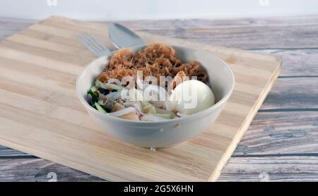 "Laksa" is a spicy noodle soup popular in the Peranakan cuisine. Selective focus of a bowl of "laksa" known in malay. Stock Photo