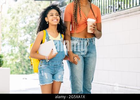 Mother taking her daughter to the school. Stock Photo