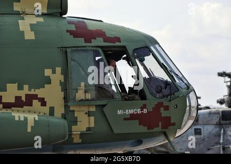 MYKOLAIV, UKRAINE - JUNE 30, 2021 - A pilot sits in the cockpit of a helicopter at the Kulbakyne aerodrome during the Exercise Sea Breeze 2021, Mykolaiv, southern Ukraine. Stock Photo