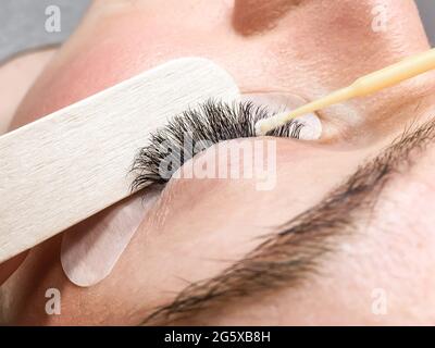 Close-up of the eyelash extension removal procedure. Portrait of a woman in a beauty salon Stock Photo