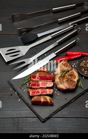 Grilled sliced roated beef steaks on stone serving cutting board Stock ...