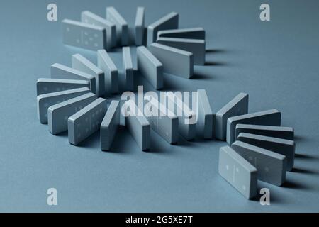 Light Blue wood domino pieces on light blue background. Leisure games concept. Stock Photo