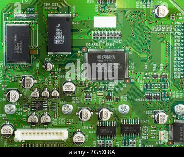Green electronic printed circuit board with computer microchips soldered in place Stock Photo