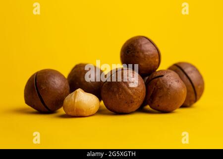 the most delicious macadamia nut on a yellow background. Stock Photo