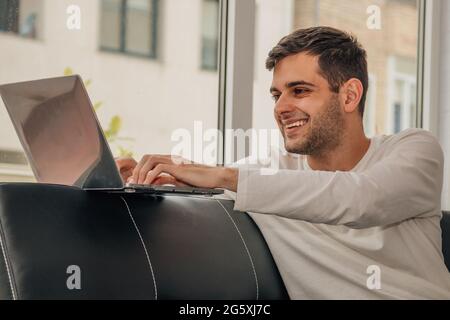 young bearded man working with laptop at home Stock Photo
