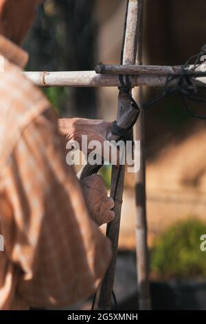 detail view of man's hands working in the field. Selective focus. Stock Photo