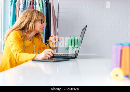 woman in workshop working with computer Stock Photo