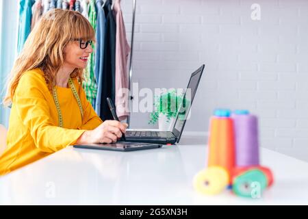 woman in workshop working with computer Stock Photo