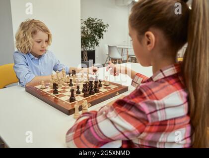 Concentrated serious boy developing chess gambit, strategy ,playing board  game to winner clever concentration and thinking child while playing chess.  Learning, tactics and analysis concept. 7292819 Stock Photo at Vecteezy